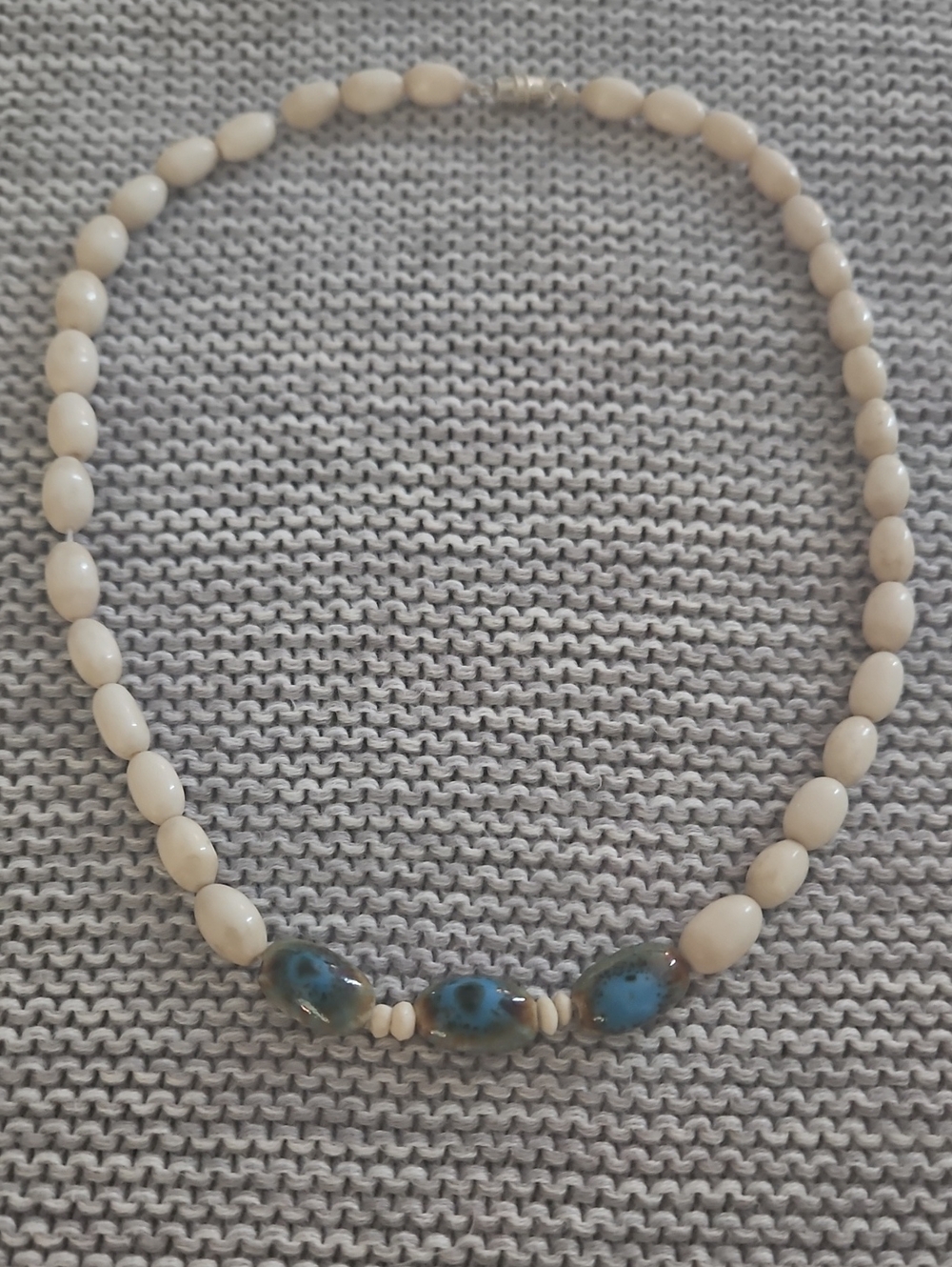 Beaded Ivory Necklace with Blue Accent Stones.